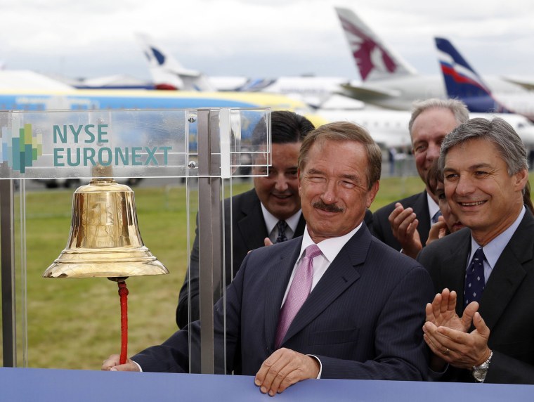 Image: CEO of Air Lease Corp. Steven Udvar-Hazy rings the New York Stock Exchange bell alongside CEO of Boeing Commercial Airplanes Ray Conner at the Farnborough Airshow 2012 in southern England